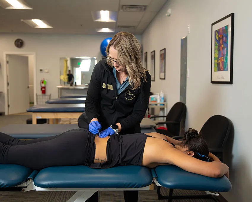 Therapist preparing a dry needling treatment