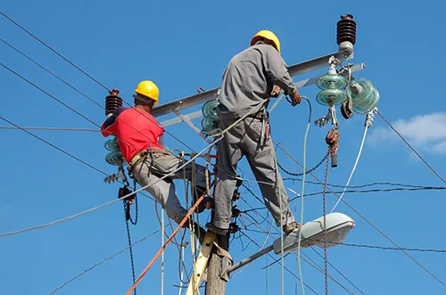 Utility linemen working on a power pole